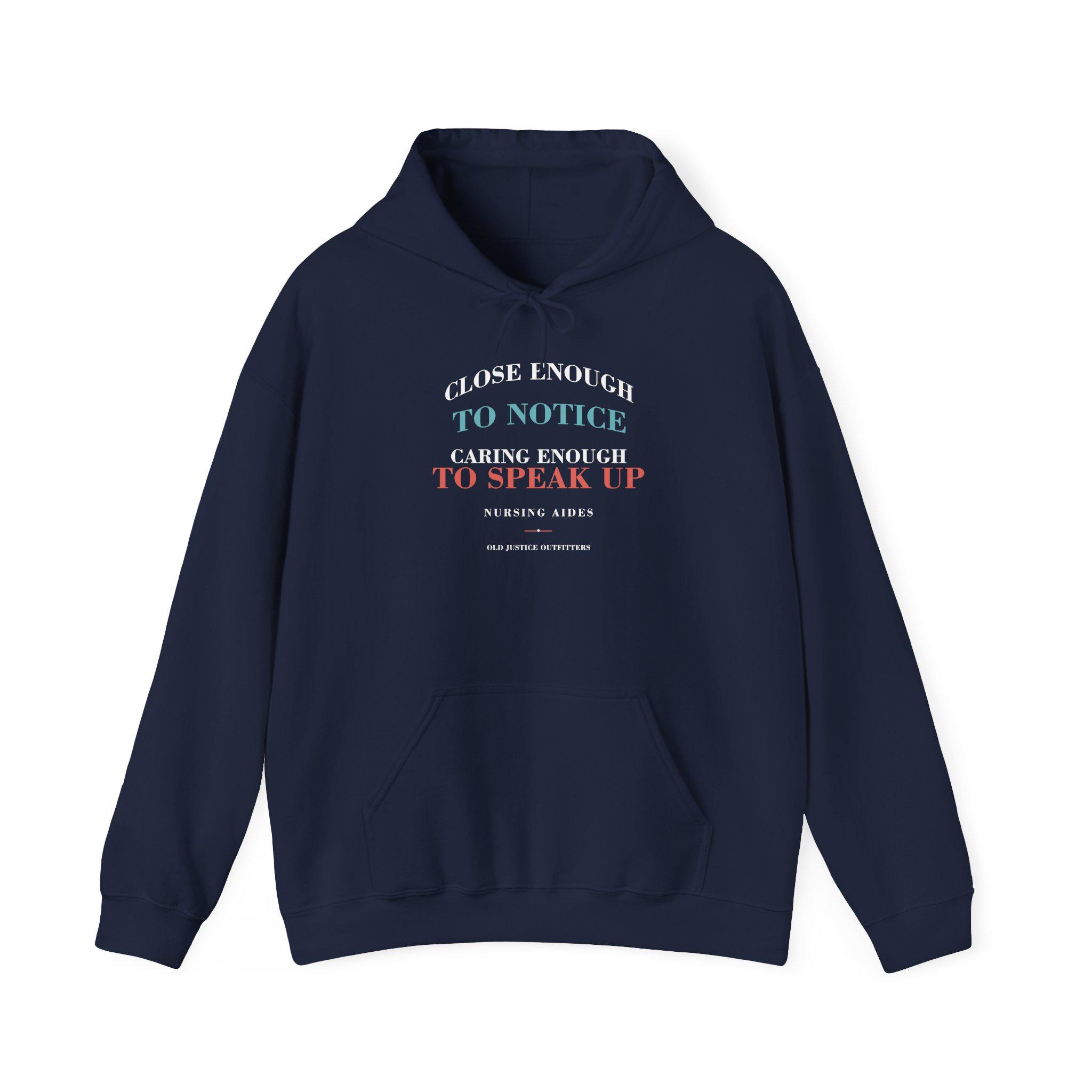 Navy nursing aide hoodie with the front message CLOSE ENOUGH TO NOTICE. CARING ENOUGH TO SPEAK UP. NURSING AIDES.